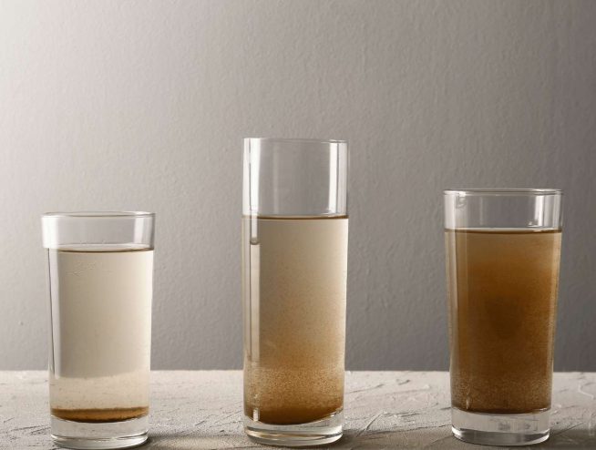 Iron content in Well water as photo of glass with different water and iron content