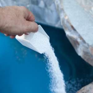 photo of chemicals added to swimming pool mannually