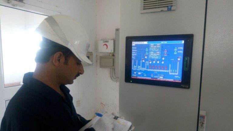 photo of an operator monitor a sewage treatment plant
